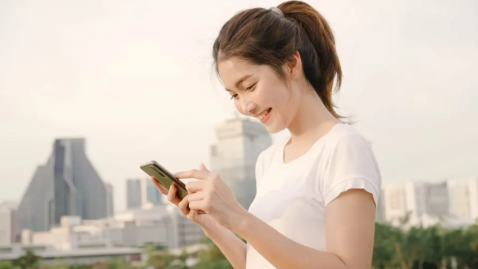 cheerful asian tourist blogger woman using smartphone direction looking location map while traveling street downtown city min scaled